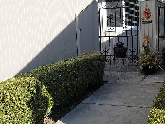 Iron Gated entry to sunny front patio