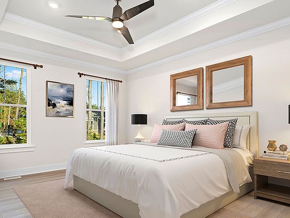 Owner s suite with tray ceiling and 2 large windows on one wall in DRB Homes Latitude home.