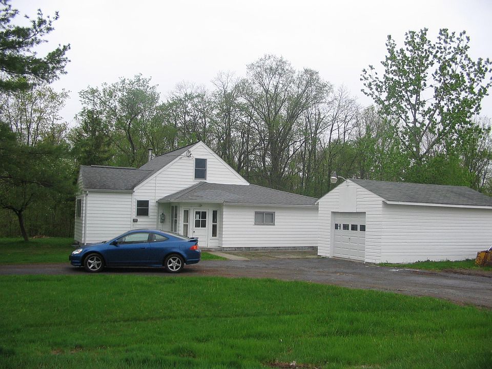 Plenty of private parking with a one car garage. Located on one full acre of land. Loop around driveway.