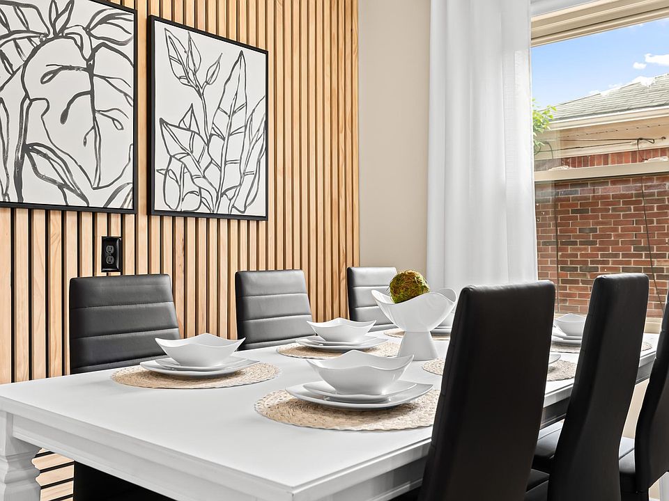 The white dishes and black chairs give this dining room a clean and modern look.