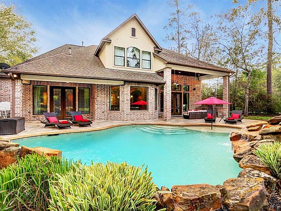 This home is a family's dream with a backyard oasis that includes a large, covered patio with an outdoor kitchen, pool, and firepit.