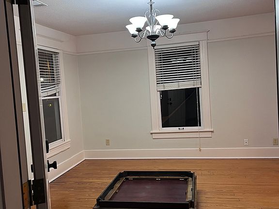 Entrance into living room. Ignore the table on the floor, it's pending removal. Freshly painted throughout. Hardwood floors.