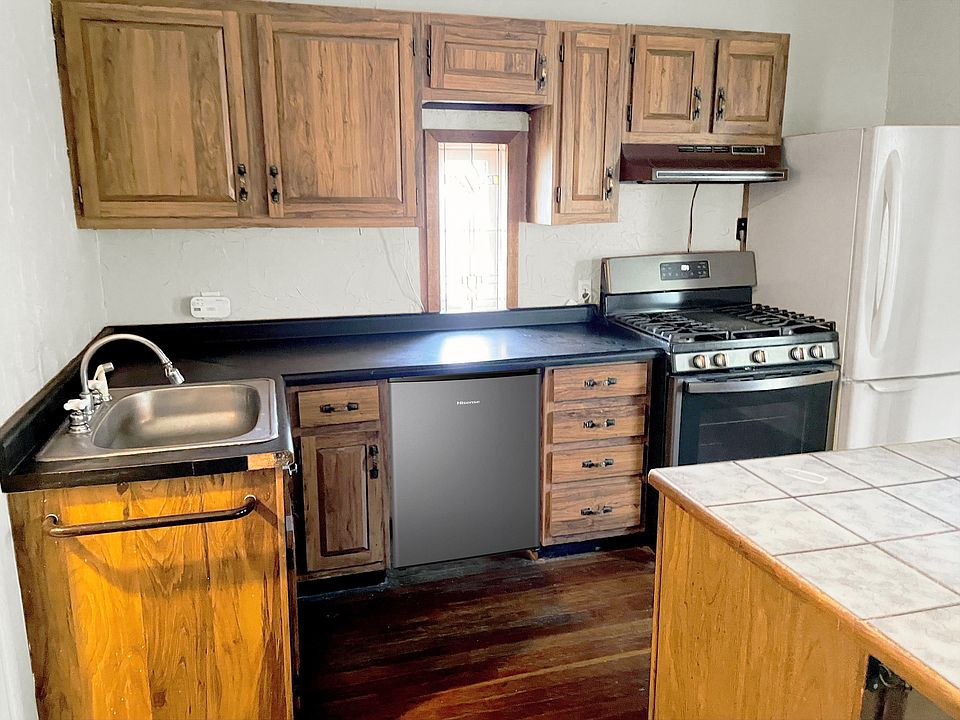 Kitchen - upper & lower cabinets, sink, gas cooktop, fridge, and island! Lots of storage and nice appliances.