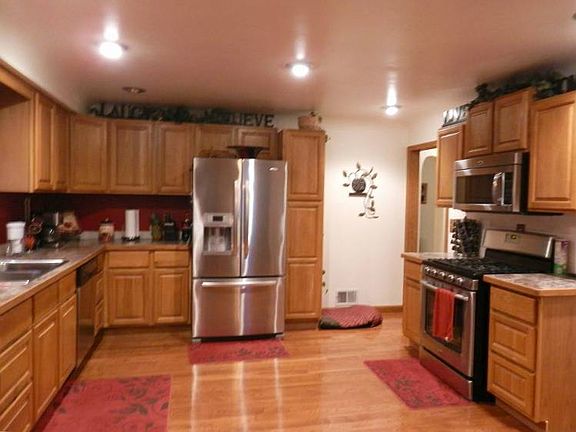 Updated kitchen cabinets with newer stainless steel appliances