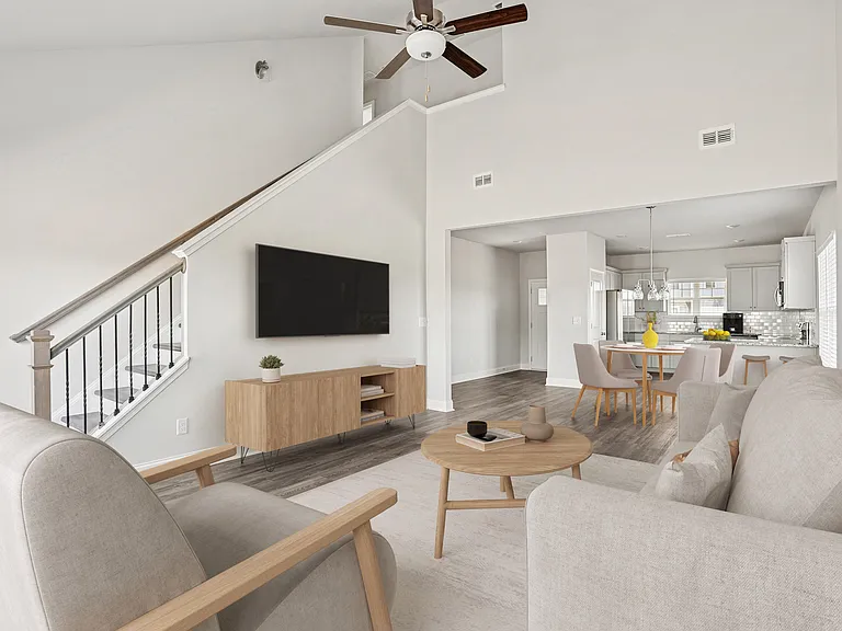 Living room with open view to kitchen and hallway.