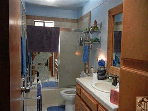Hallway bath features shower over tub.