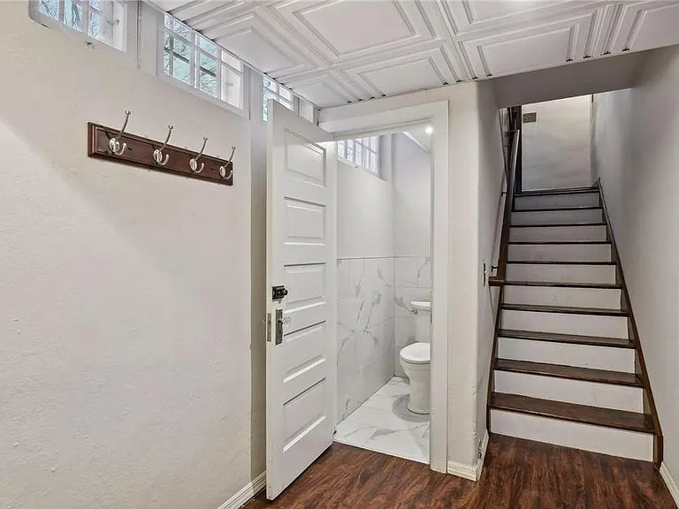 Private entrance stairway from driveway and half-bath