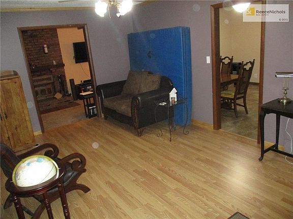 Step inside the living room and look at those new laminate floors! Just beyond the living room is the kitchen/dining room combo. To the left is the family room.