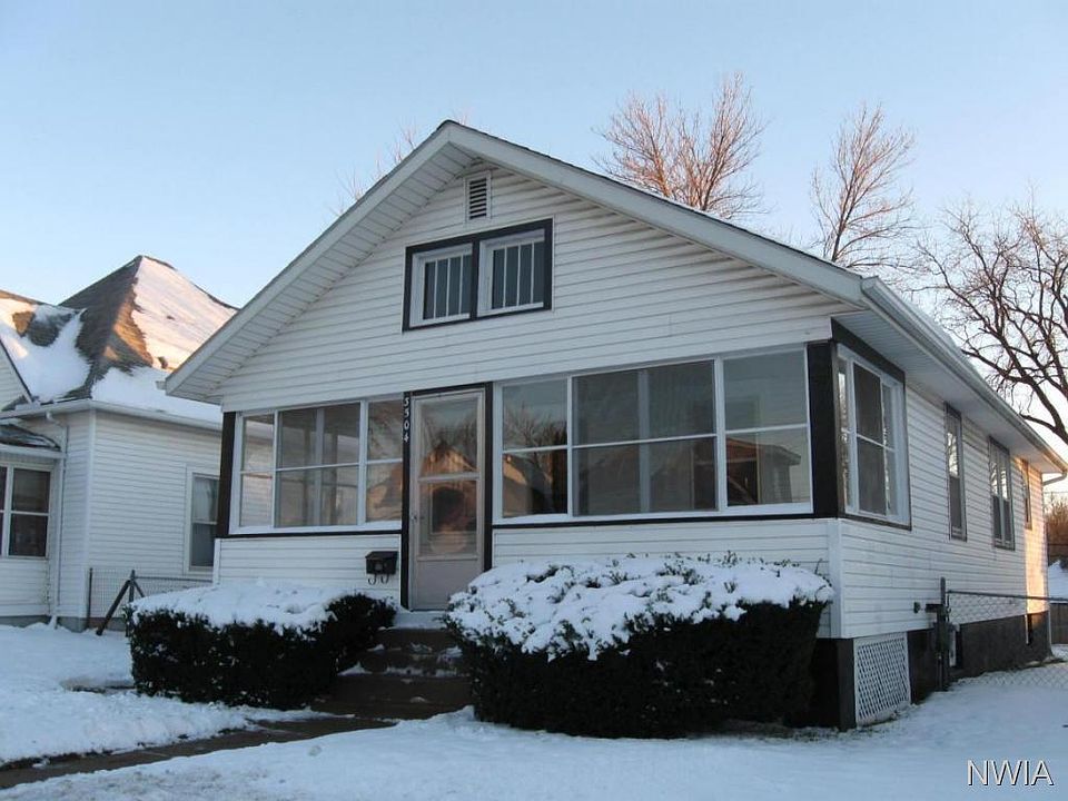 Street view with 3 season porch and fenced yard