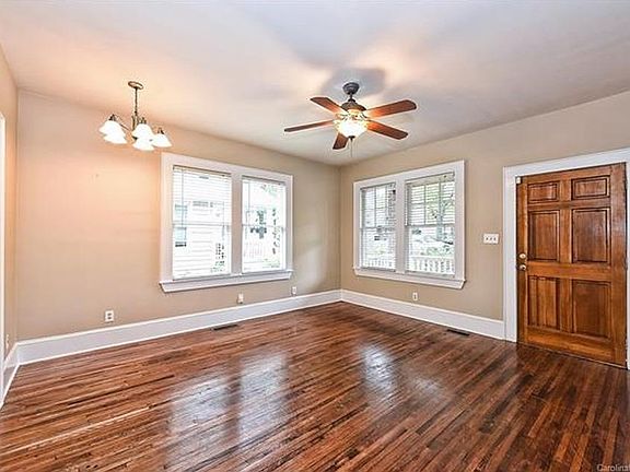 Well lit living room with direct access to kitchen