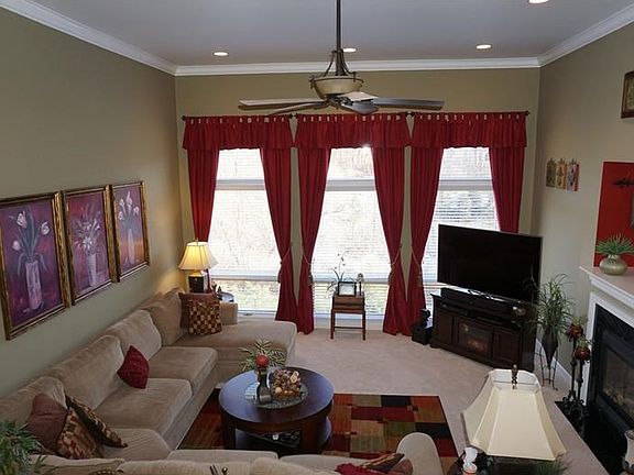 The living room / family room is the heart of this home!  The room offers 12' ceilings, recessed lights, see thru fireplace to the kitchen and 3 large windows to enjoy the private rear yard!