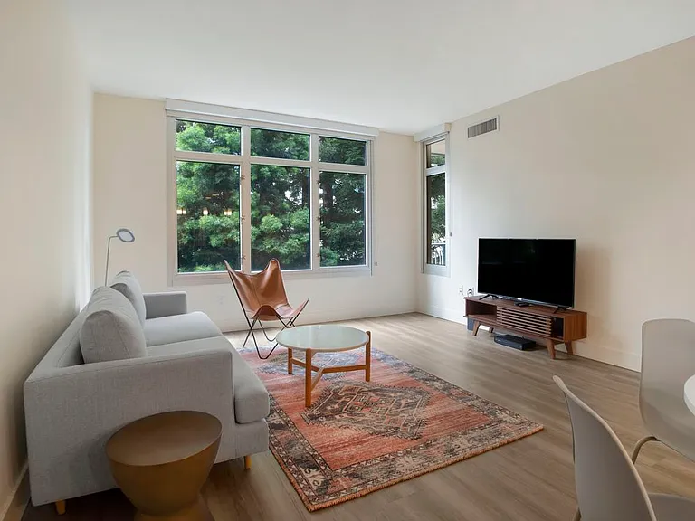 Furnished+ apartment homes come outfitted with a sofa, side chair, side table, coffee table, TV stand and 50" Television (Representative Image exact items and style of furnishings may vary)