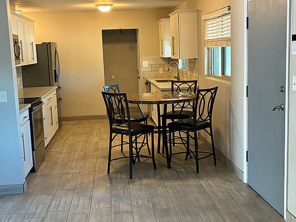 Front door to the right. Galley kitchen 10 1/2 ft wide X 15 ft long. Table stays.