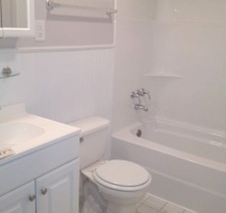 Clean, crisp bathroom, with glass block to maximize light