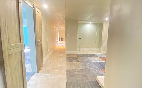 Hallway leads to the laundry area, bonus family room, two bedrooms and a dedicated storage room.