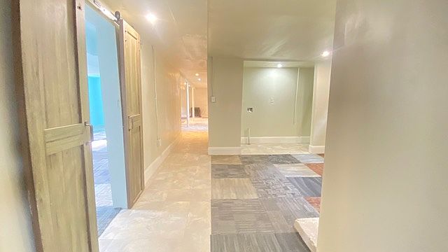 Hallway leads to the laundry area, bonus family room, two bedrooms and a dedicated storage room.