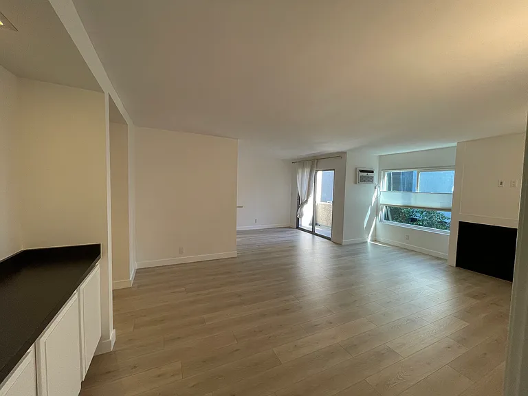 Large living room with a bar area on the left with extra storage
