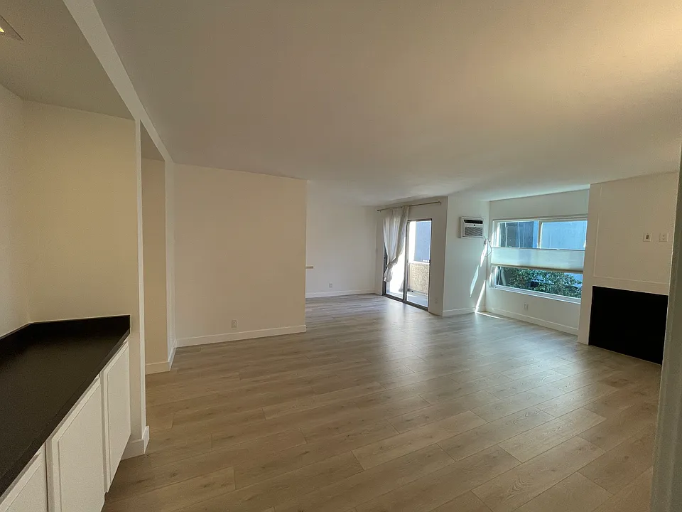 Large living room with a bar area on the left with extra storage