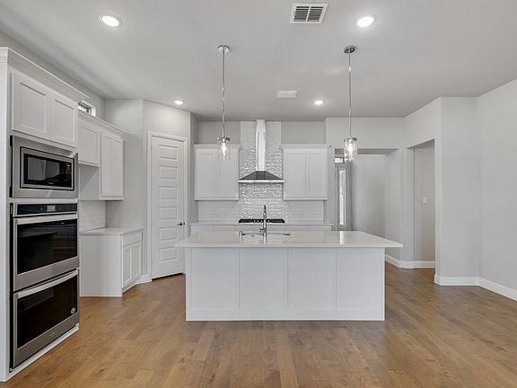 Kitchen in the Van Gogh home plan by Trophy Signature Homes - REPRESENTATIVE PHOTO