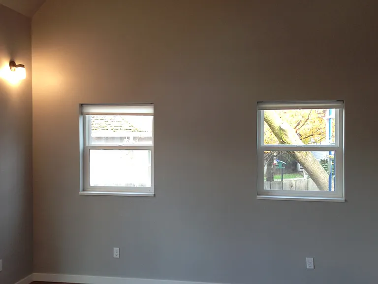 Vaulted ceiling and lots of light in primary bedroom