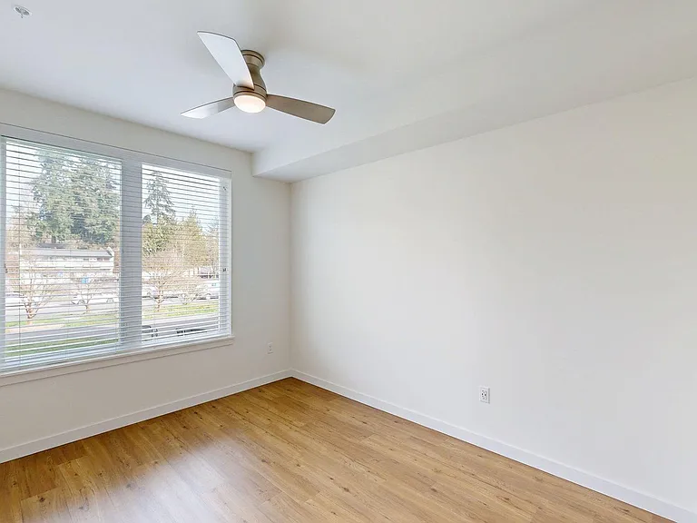 Spacious apartment Bedroom with Wood-Style Flooring.