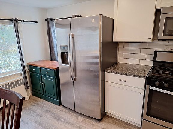 Kitchen includes buffet cabinet that is on wheels and can be moved around to be a temporary island