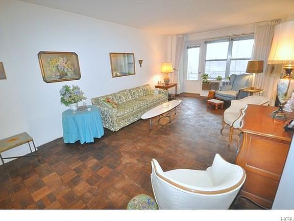 Large Sunny living room opens to the Dining Room.  There is a door leading to the balcony overlooking Garth Park and Playground.  The room has parquet floors, a large walk-in closet and is 30'-2" x 12'-4".