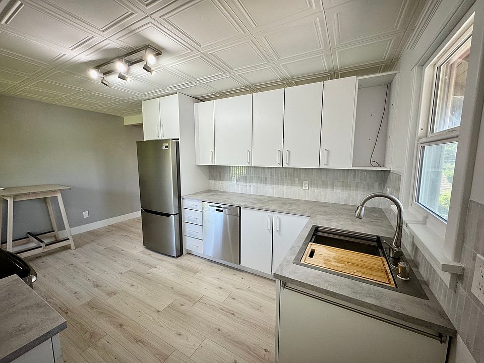 New fridge and Bosch dishwasher; features a deep single-basin sink with cutting board, strainer and drain rack attachments
