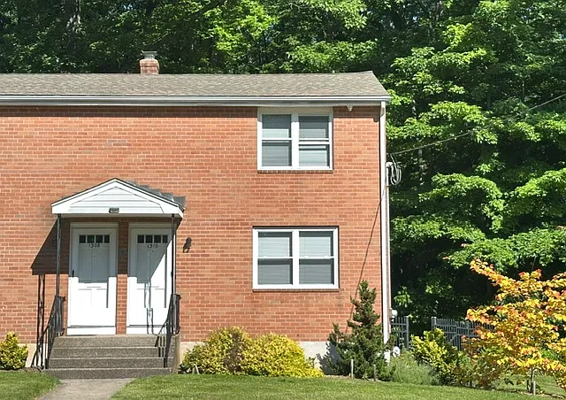Home features lovingly-cared for landscaping.