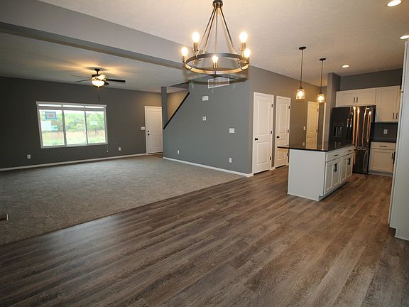 Image shows upgraded LVP flooring and upgraded painted trim.