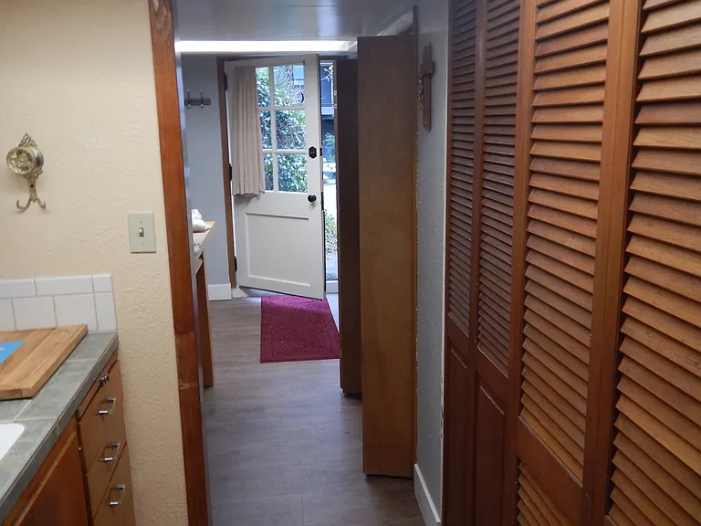 view from kitchen area into eating area and outside door.