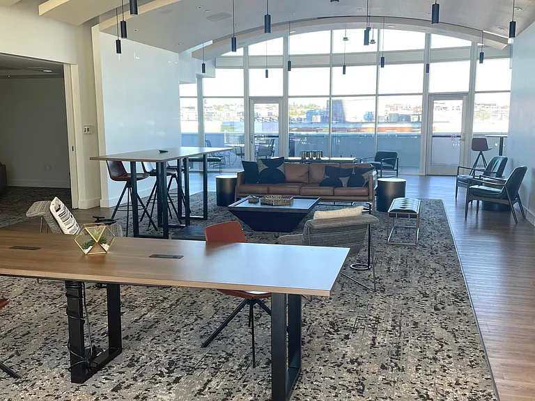 Eighth-floor clubhouse with work spaces, kitchenette, and communal gathering area with media room.