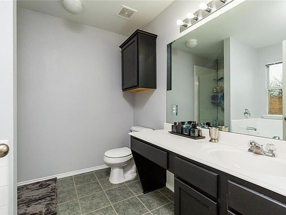 Master bath has separate shower and garden tub, lots of counter space.