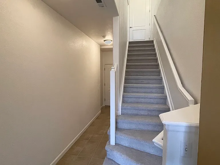 Stairs from lower level with large storage closet, and huge 2 car extended storage space garage. All living space is upstairs.l