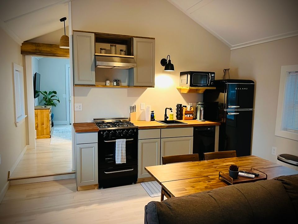 Kitchen area has gas stove, sink, dishwasher, refrigerator, coffee maker