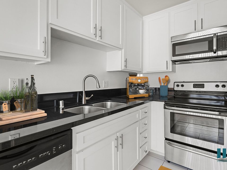 Kitchen with Stainless-Steel Dishwasher, Stove, Microwave Oven, and Refrigerator