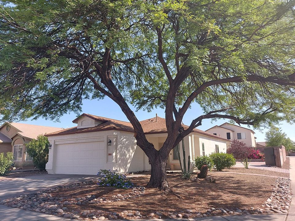 Large tree on this corner home provides plenty of shade on driveway and in street alongside residence.