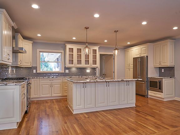 Open floor plan kitchen and living area. Island measures 7' x 4'.