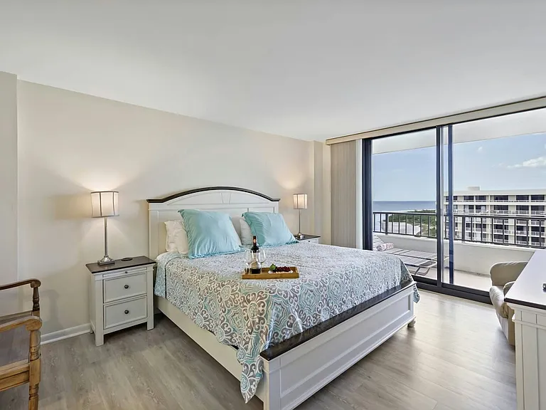 Primary bedroom with a luxurious king bed and private balcony