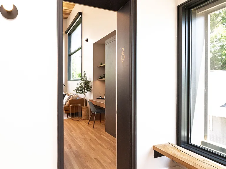 The front entry opens up to the kitchen workspace and living room.