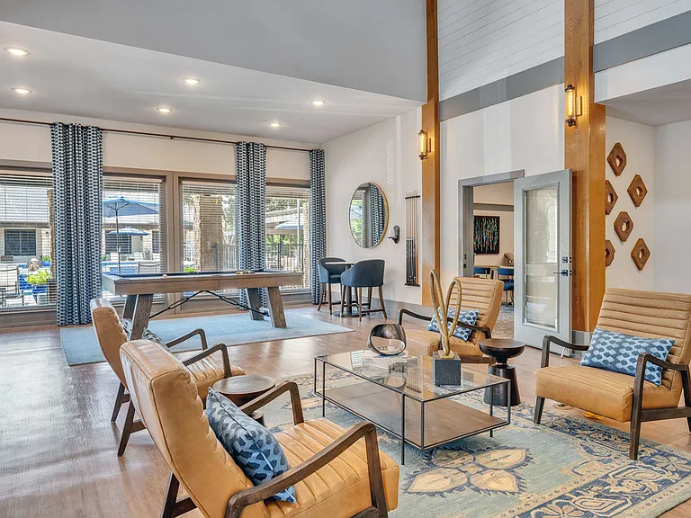 Enjoy comfortable seating and a pool view from the resident lounge
