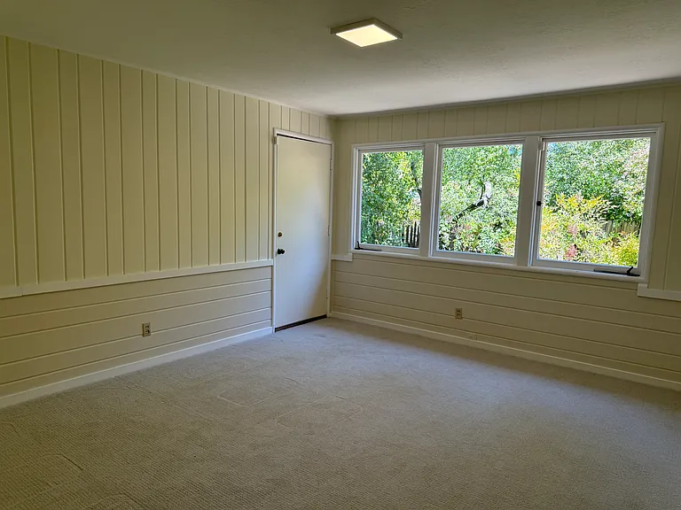 Bedroom #2 with a door to small side yard.