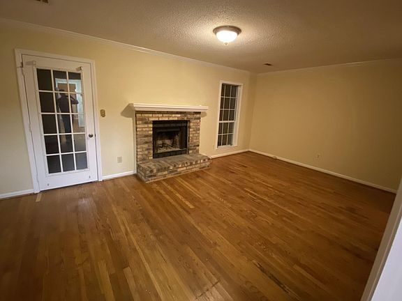 Living Room with Fireplace, leading to Patio