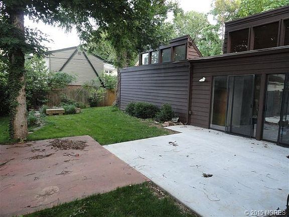 PICTURESQUE BACKYARD WITH MATURE TEES CONNECTED TO ENCLOSED BREEZEWAY