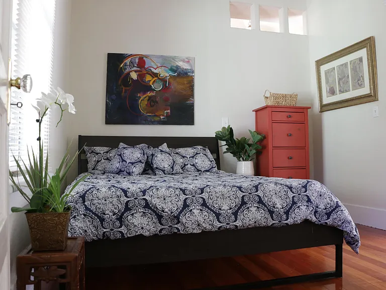 Main bedroom has hardwood floors, double-hung, original windows and more custom carpentry/windows to allow natural light throughout.