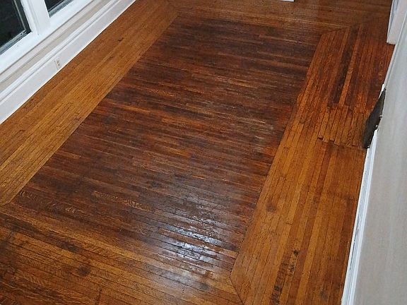 living room with hardwood floors and faux fireplace