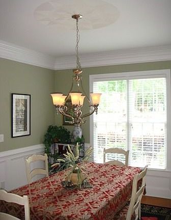 Elegant Dining room w/ judges paneling, dental molding, hardwood floors.