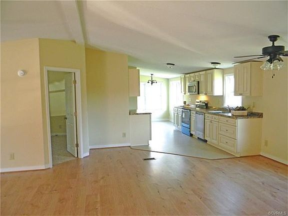 Kitchen with eat in area in the back and Master on left
