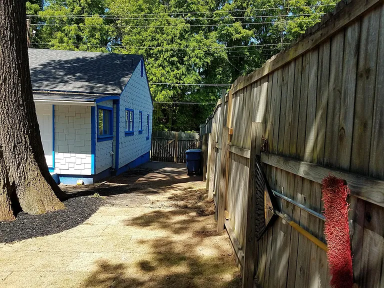 At the right back fence looking at the driveway