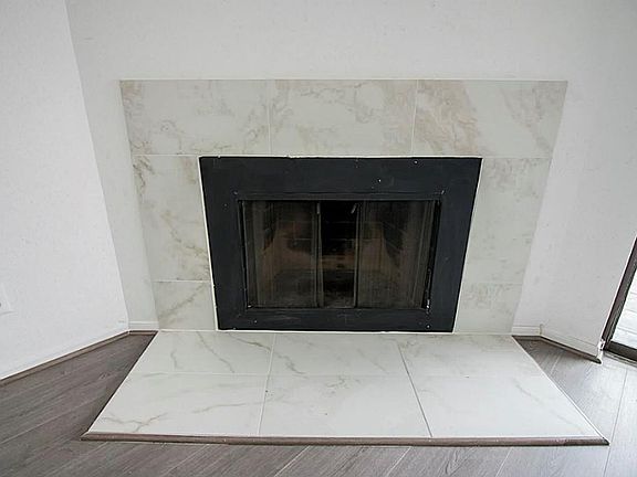 Marvelous wood burning fireplace with lovely marble-like porcelain tile.
